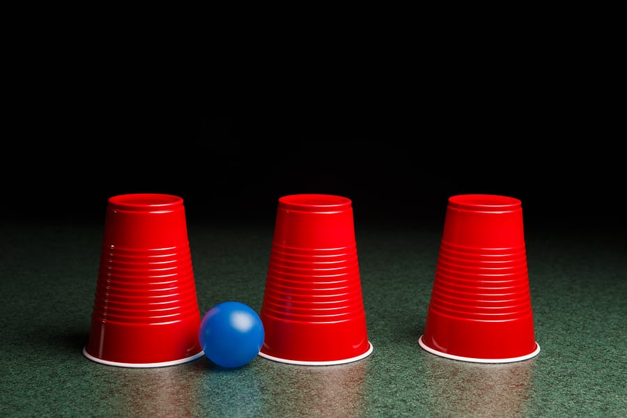 Three red cups and a blue ball