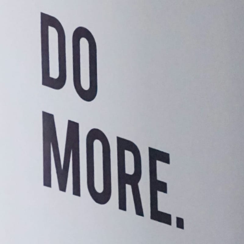 Framed picture saying "do more" white and gray